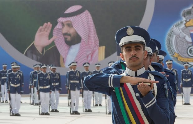 Cadets of the 93rd batch of the cadets of King Faisal Air Academy participate in a graduation ceremony as a picture of Saudi Arabia's Crown Prince Mohammed bin Salman is seen, in Riyadh