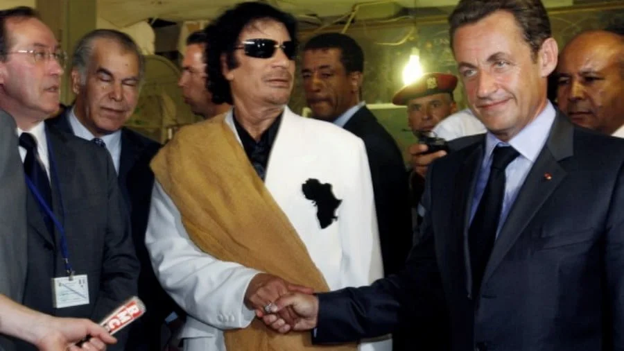Gaddafi’s Ghost Haunts Walking-Dead King Sarko