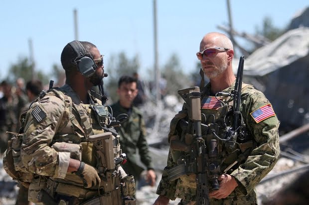 FILE PHOTO: U.S. forces are seen at the Kurdish People's Protection Units headquarters after it was hit by Turkish airstrikes in Mount Karachok near Malikiya