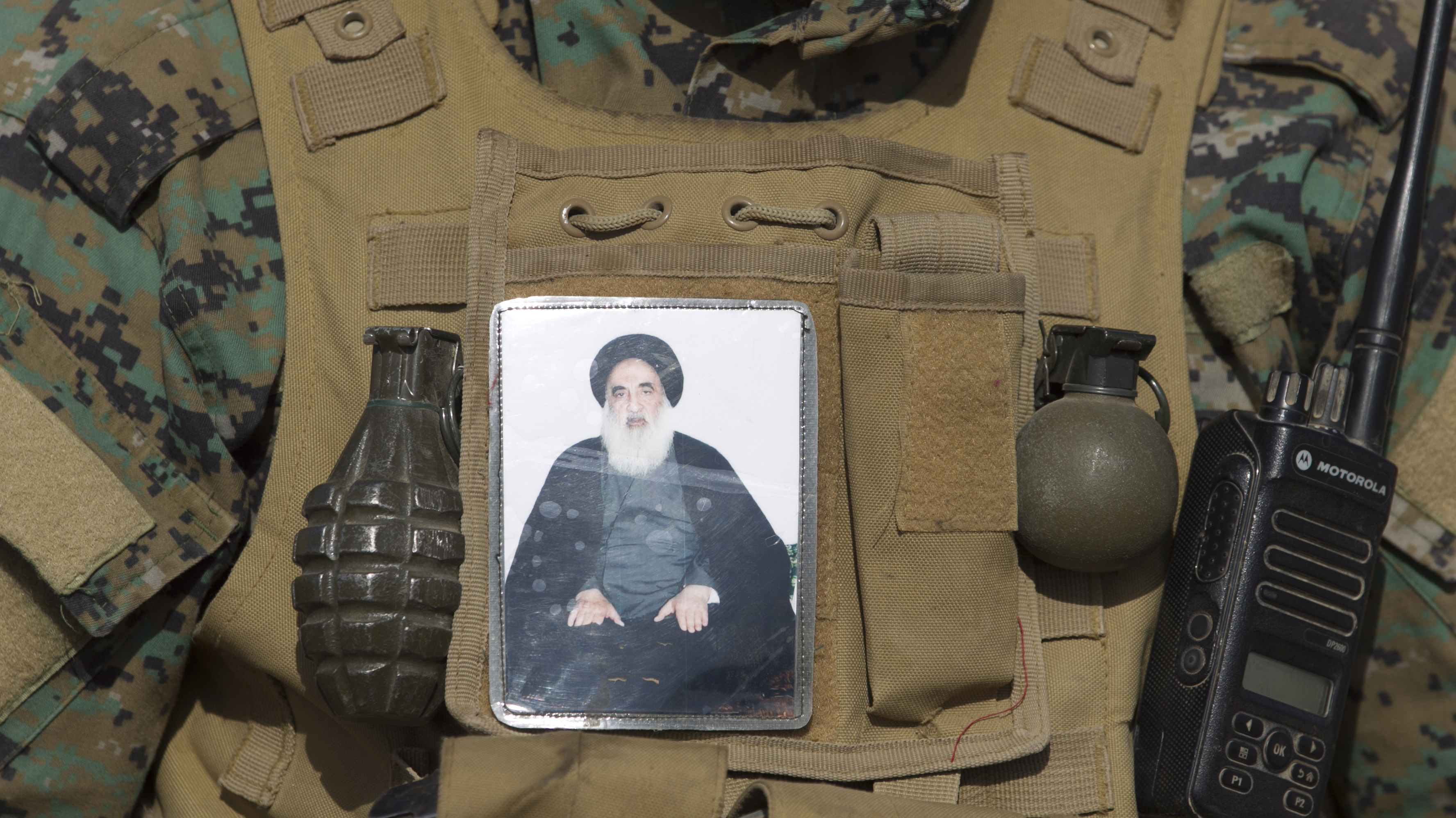 An Iraqi Shiite fighter from the Popular Mobilization Units wears an image of Iraqi Ayatollah Ali al-Sistani on his vest during the advance against Islamic State forces near the village of Tal Faris, Nov. 29, 2016 (photo by Ahmad al-Rubaye/AFP/Getty Images)