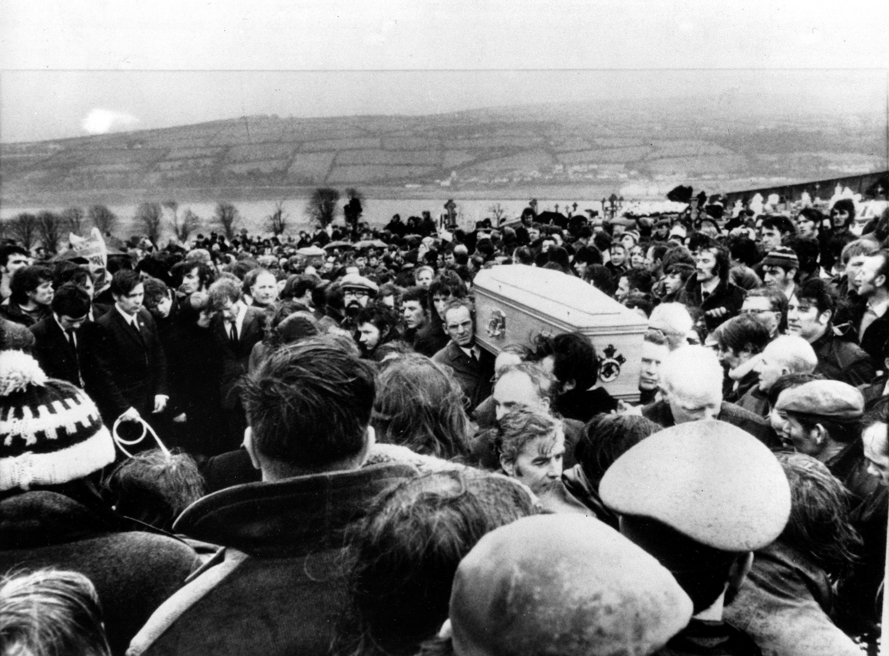 In this Feb. 2, 1972, file photo Pallbearers carry one of 13 coffins of Bloody Sunday victims to a graveside during a funeral in Derry, Northern Ireland, following requiem mass at nearby St. Mary's church at Creggan Hill. © AP Photo
