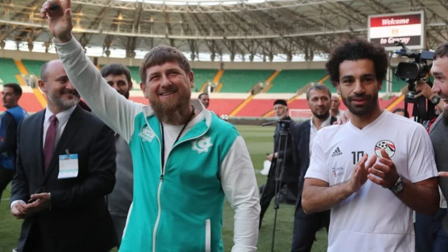 Chechen leader Ramzan Kadyrov, left, waves while standing by Egyptian football star Mohamed Salah, right, during a training run for the Egyptian team at the Akhmat Arena in Grozny on June 10, ahead of the Russia 2018 World Cup. Photo: AFP/ Karim Jaafar