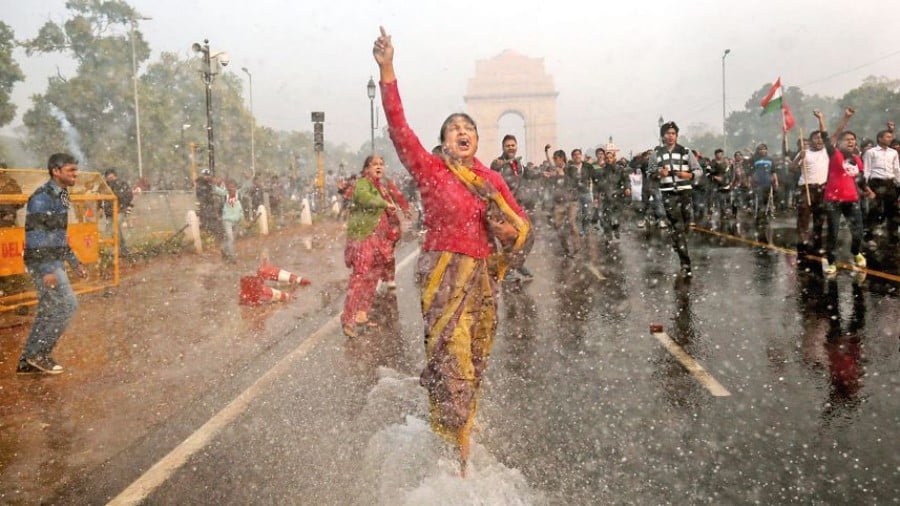 A protester is hit with a police water cannon during a violent demonstration near the India Gate against a gang rape and brutal beating of a 23-year-old student on a bus in New Delhi, India, Dec. 2012 AP
