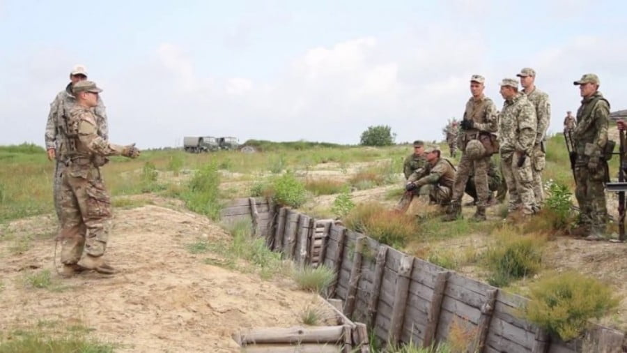 U.S. instructors and Ukrainian Army soldiers review assault on defensive positions and clearing of trenches at the Yavoriv training center.