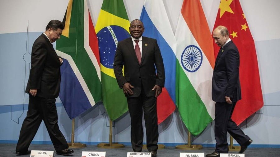 China's President Xi Jinping, South Africa's President Cyril Ramaphosa and Russia's President Vladimir Putin arrive for a group picture during the 10th BRICS summit on July 26, 2018 in Johannesburg. Photo: AFP/Gianluigi Guercia