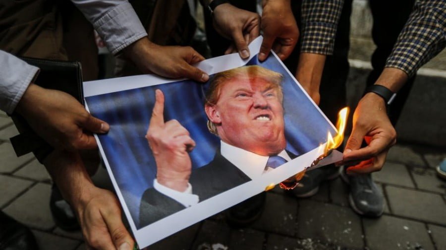 Iranians burn an image of US President Donald Trump during an anti-US demonstration outside the former US embassy headquarters in the capital Tehran on May 9, 2018. Photo: AFP/Atta Kenare