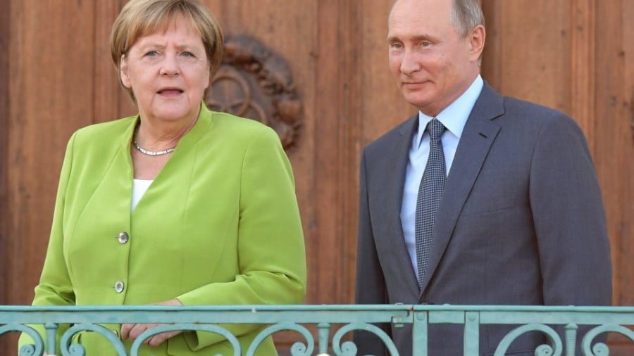 Russian President Vladimir Putin and German Chancellor Angela Merkel take to the stage during a meeting at the German government guesthouse in Meseberg. Photo: AFP/Sergey Guneev/Sputnik