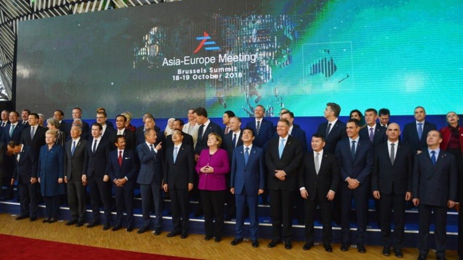 Asian and European leaders gather at the ASEM 12 summit last week with German Chancellor Angela Merkel, center in purple, for a group photo in Brussels on October 19, 2018. Photo: Alexey Vitvitsky / Sputnik / AFP