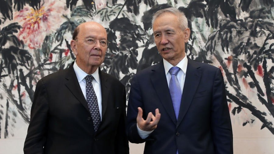 US Commerce Secretary Wilbur Ross, left, chats with Chinese Vice-Premier Liu He during 'trade dispute' talks in Beijing earlier this year. Some sort of agreement could be reached at the G20 summit. Photo: AFP / Andy Wong