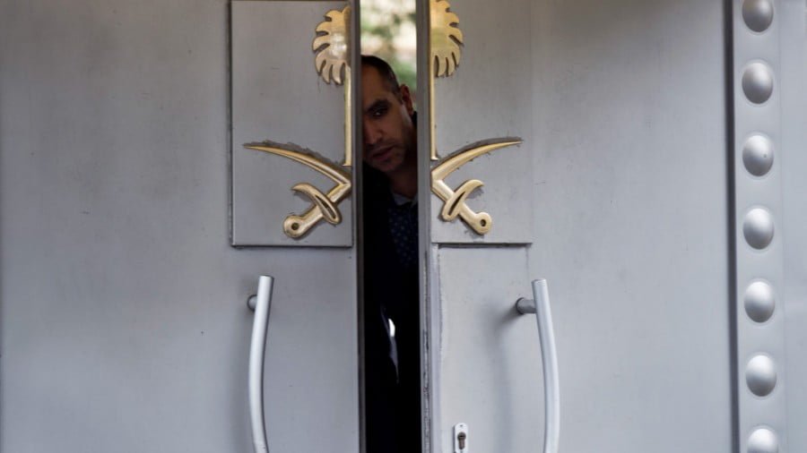 A security personnel looks out from the entrance of the Saudi Arabia’s consulate in Istanbul, Oct. 14, 2018. Jamal Khashoggi, Saudi critic, vanished after he walked into the consulate on Oct. 2. Petros Giannakouris | AP