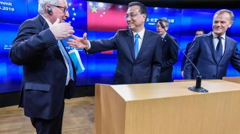 Chinese Premier Li Keqiang moves to shake the hand of Jean Claude Juncker, left, President of the European Commission, as Donald Tusk, head of the European Council watches, after the EU-China Summit in Brussels on 9 April 2019. Photo: AFP / Riccardo Pareggiani / NurPhoto
